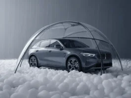 Automobilis, saugiai apsaugotas po skaidriu kupolu per stiprią krušą.